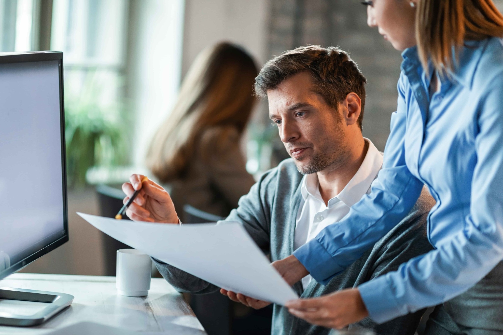 Underwriting professionals reviewing documents together