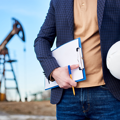 Mining professional holding a clipboard and hard hat